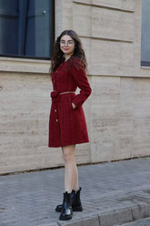 a lady in a red tweed dress with a belt